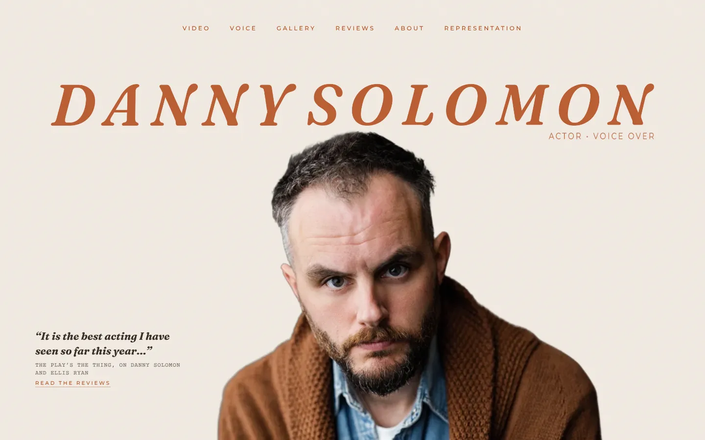 Hero: the name in rust italic capitals, Danny in a brown cardigan, a press line on the left